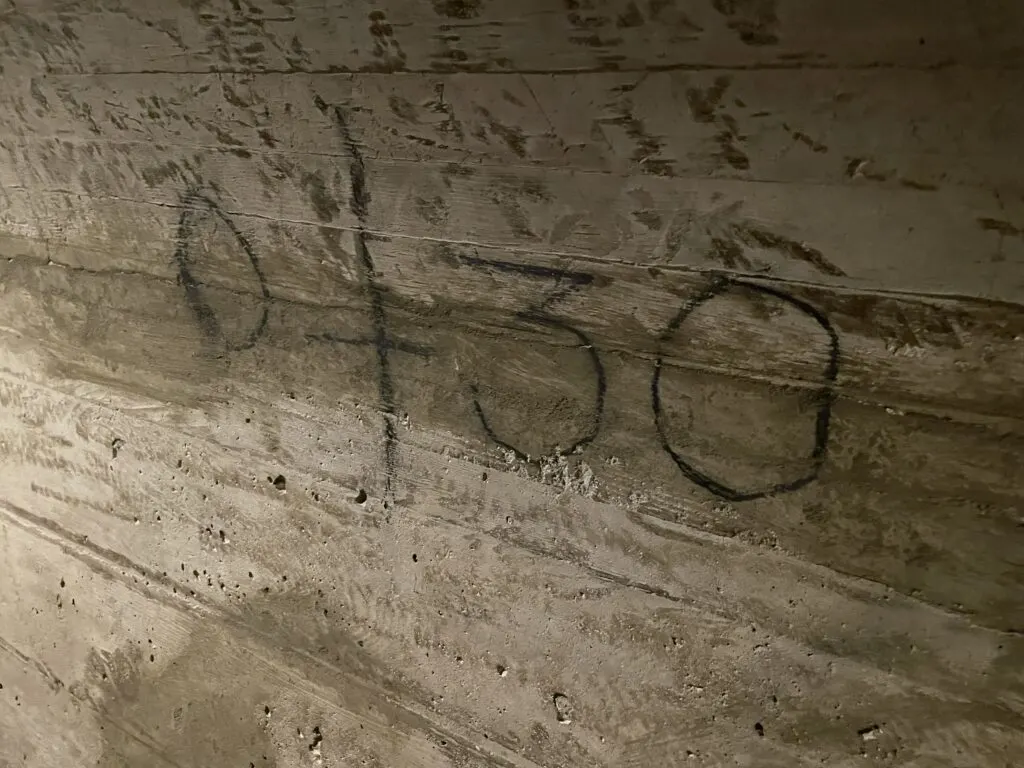 "0+30" written on the concrete wall in dark ink