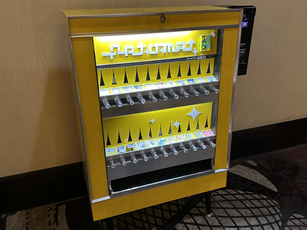 A bright yellow art vending machine with numerous items to purchase for $5. 