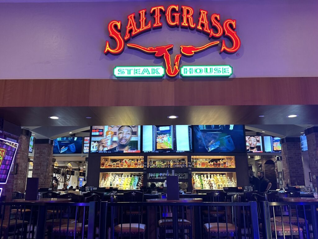 Exterior of Saltgrass at Golden nugget. Slot machines are visible in front of the restaurant.