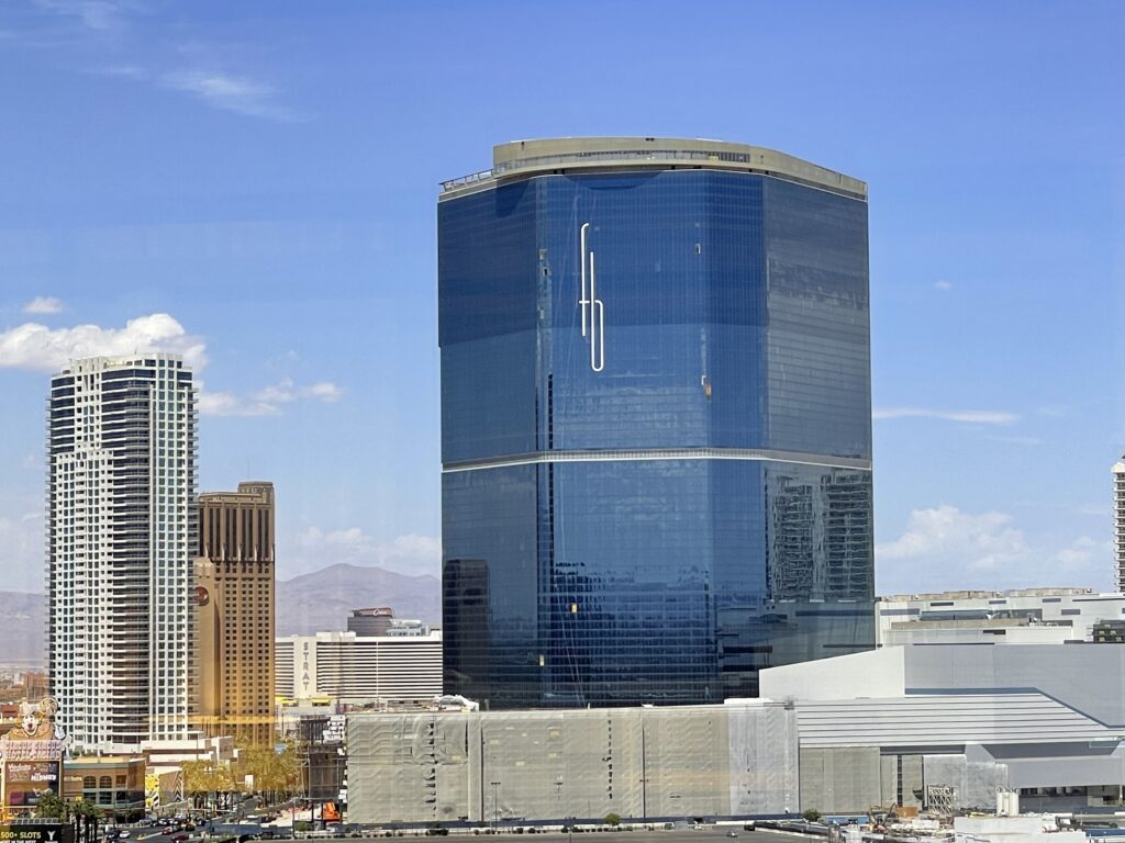 Fontainebleau's blue hotel tower with a sign hanging on it that says "FB" in lowercase letters.