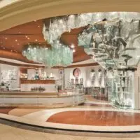 Exterior of Bellagio's Patisserie with a large glass chocolate fountain on the right that extends from the ceiling to the floor