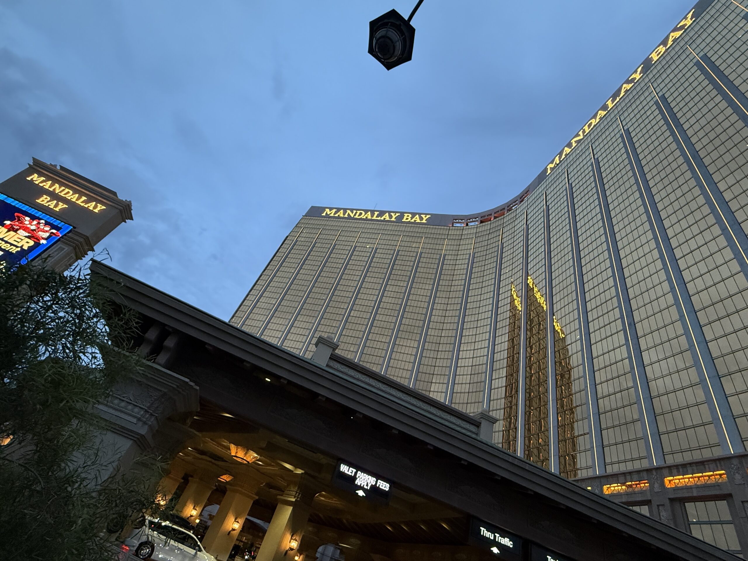 Mandalay Bay's hotel tower at dusk with the blue sky in the background.