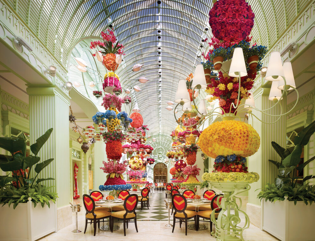 Seating at Wynn's buffet with a glass ceiling and colorful floral decor