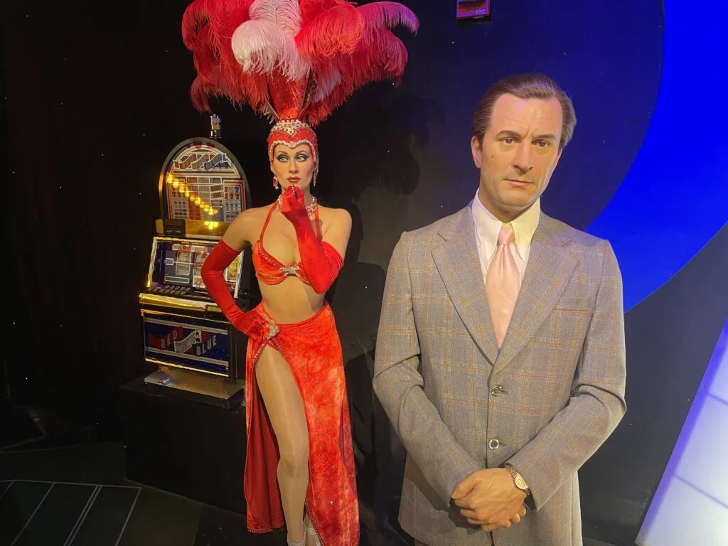 Ace Rothstein from the movie Casino poses with a showgirl dressed in Red. 