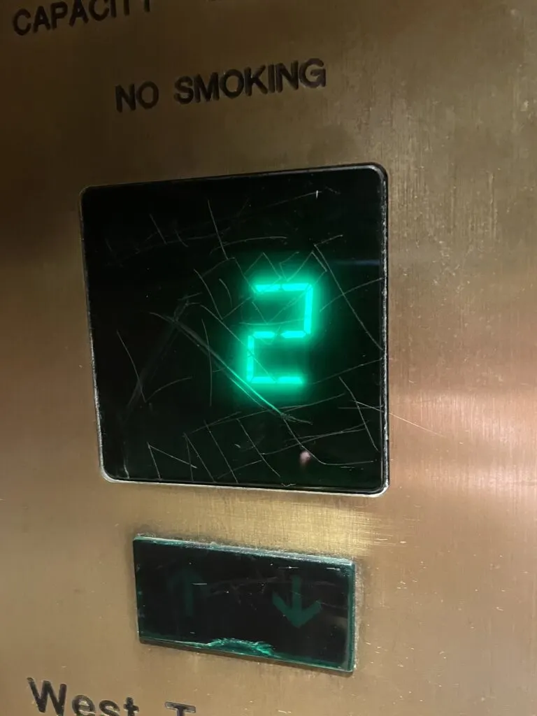 The sign in the elevator that shows what floor you're on with carved grafiti on it.