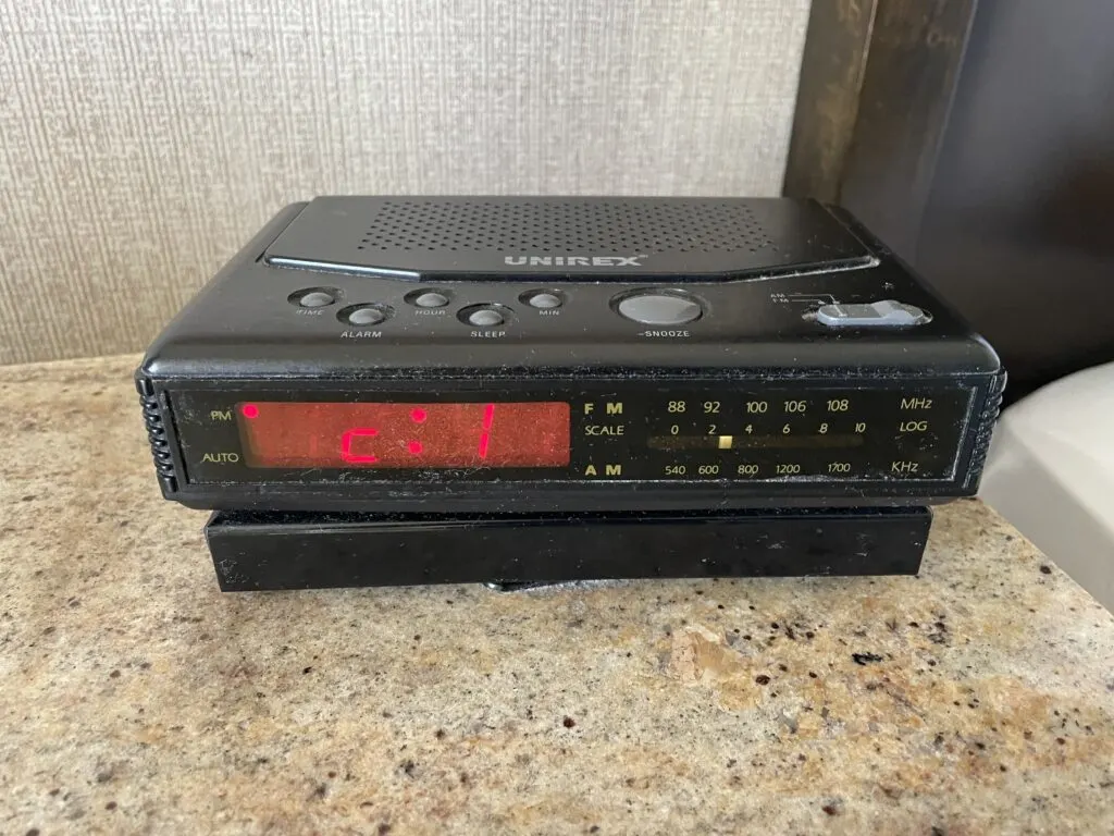 An old model digital alarm clock that was likely produced in the early 1990s.