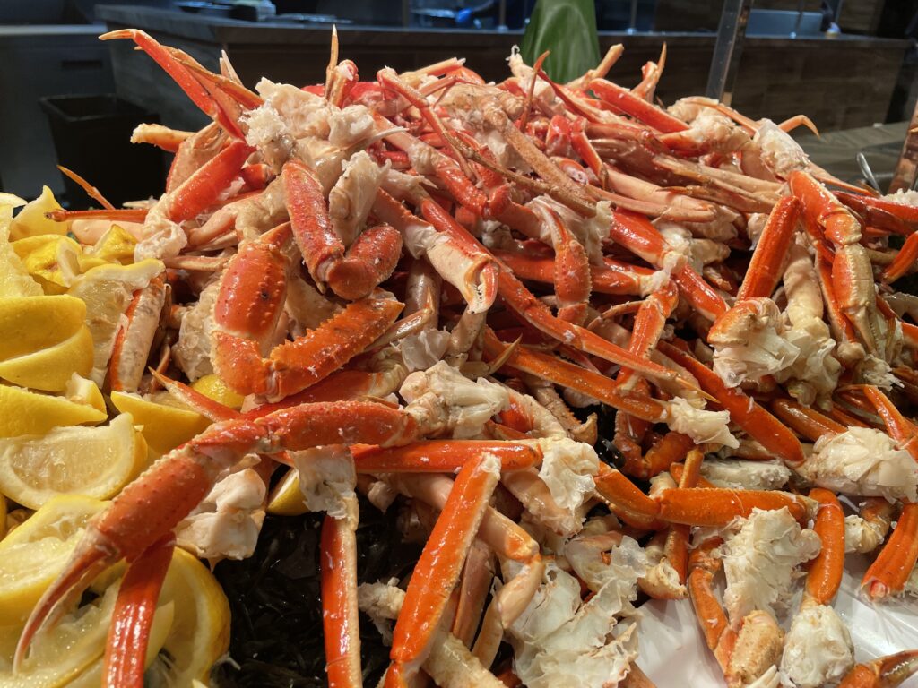 A pile of crab legs flanked by cut lemons.