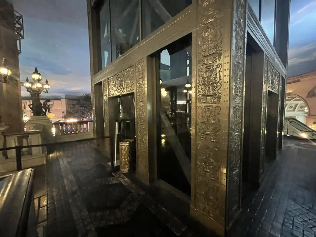 2 elevators built into one of the Eiffel Tower's legs, which are plated in intricately decorated metal plating.