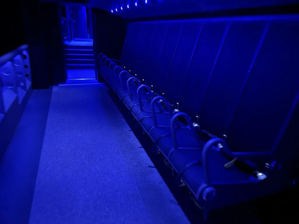 A row of seats equipped with seatbelts that riders sit in for the FlyOver Vegas attraction