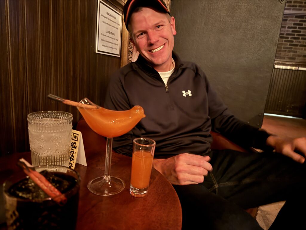 Me, posing in front of my pink drink... served in a glass shaped like a bird.