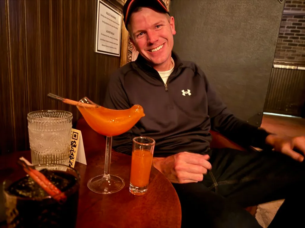 Me, posing in front of my pink drink... served in a glass shaped like a bird. 
