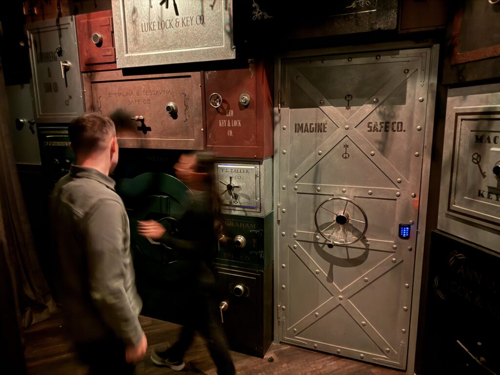 My brother, in front of a wall of safe doors.