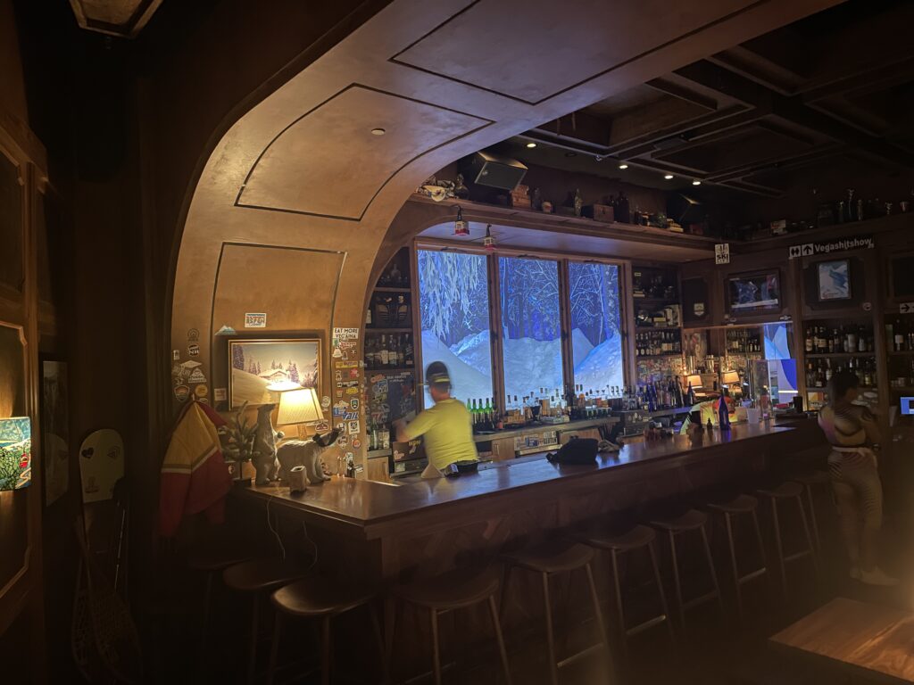 Interior of The Ski Lodge with LED screens behind the bar simulating windows overlooking a snowy landscape