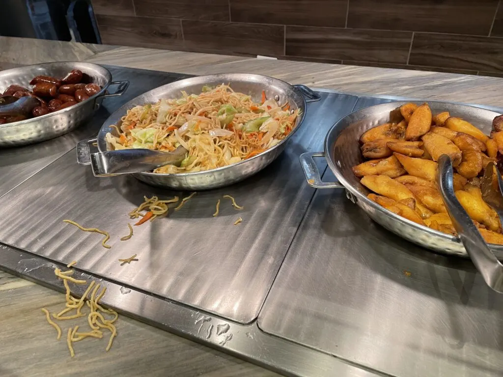 Bowls of Vegetable chow mein, maduro plantains, and filipino longanisa.