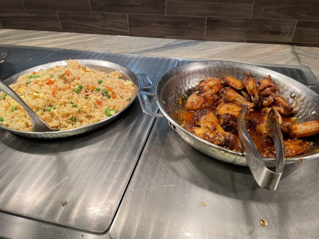 Bowls of fried rice and Tariyaki chicken wings.