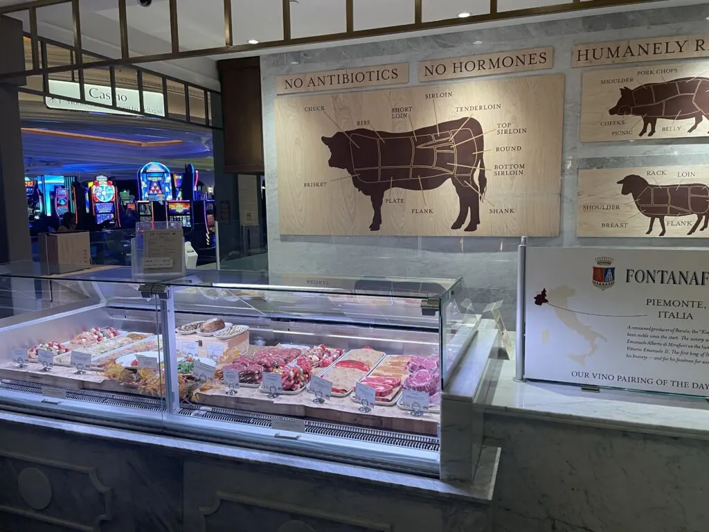 The butcher storefront with raw meat in a display ase.