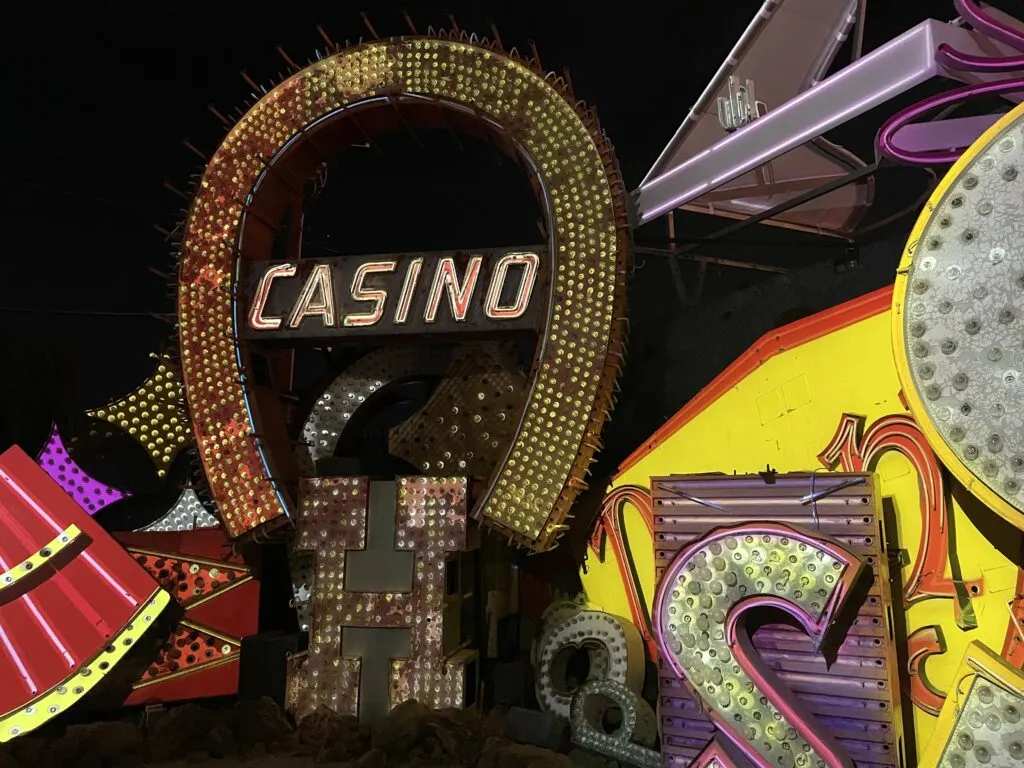 A large upside down Horseshoe with the word "Casino" in the middle of it, surrounded by a collection of other illuminated signage.