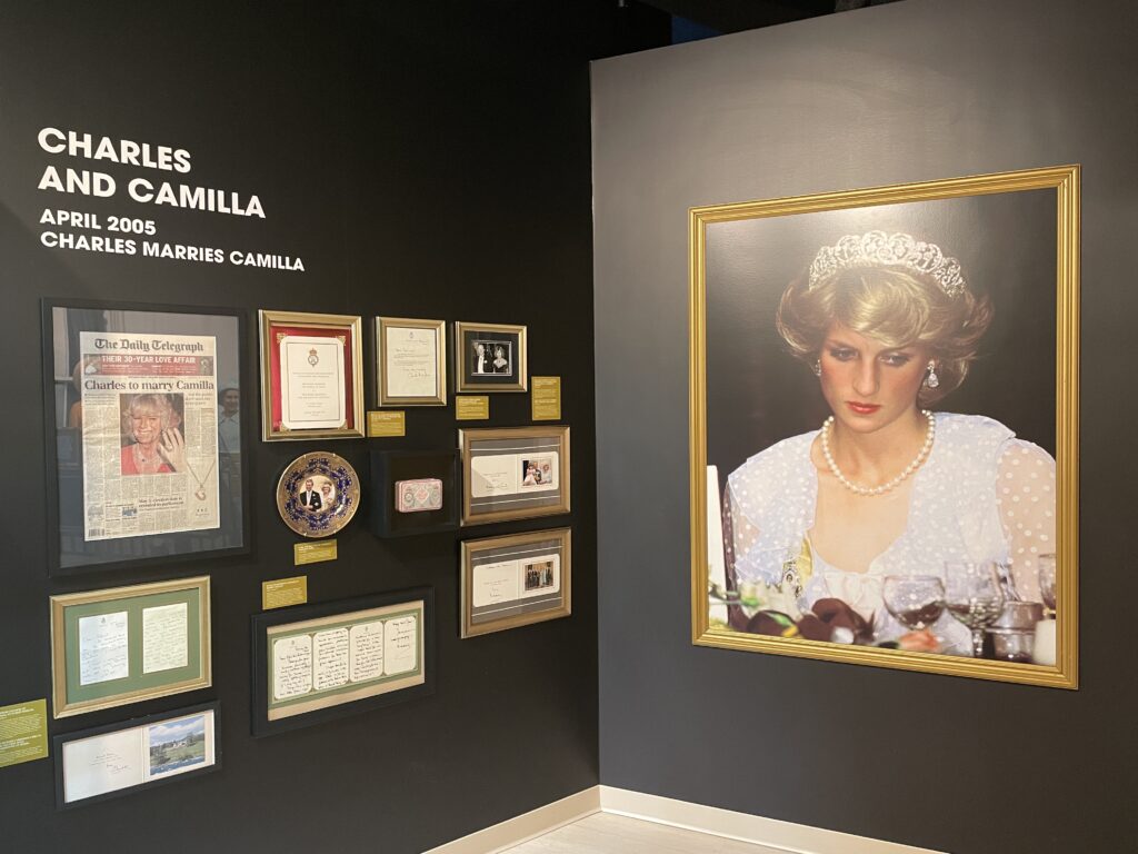 A wall depicting aftifacts and information about Charles' relationship with Camilla. 