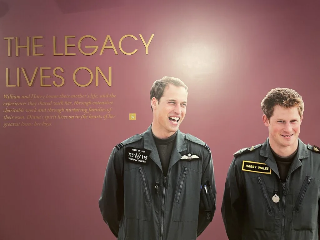 A wall with a large image of Harry and William in a military uniform with the phrase "The Legacy Lives On".