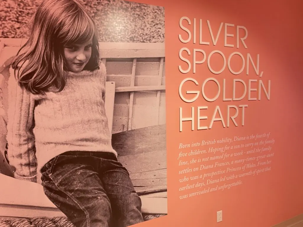 A wall display with a photo of Diana as a child titled "Silver Spoon, Golden Heart"