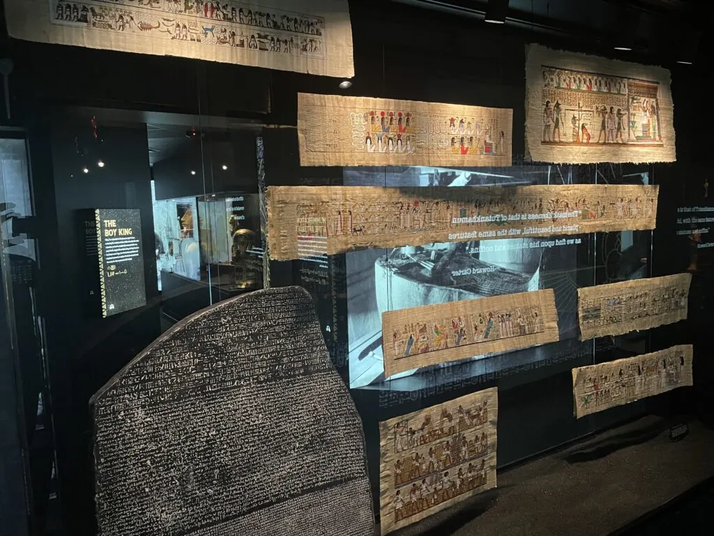 Scrolls are displayed behind glass. 