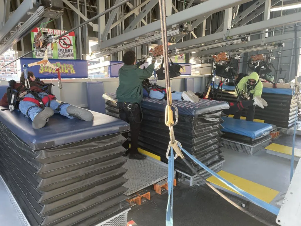 Staging area for zipline riders with tables for them to lay on while they are rigged up.