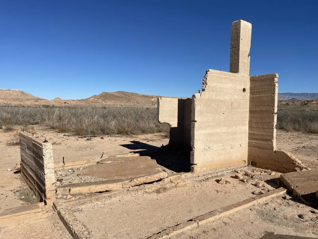 Hanning Store ruins, with few walls standing and a chimney to the right.