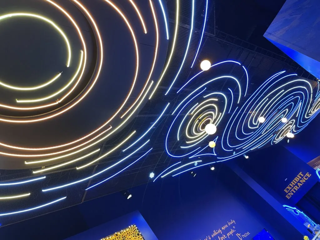 Neon art on the lobby ceiling that resembles Van Gogh's Starry Night.