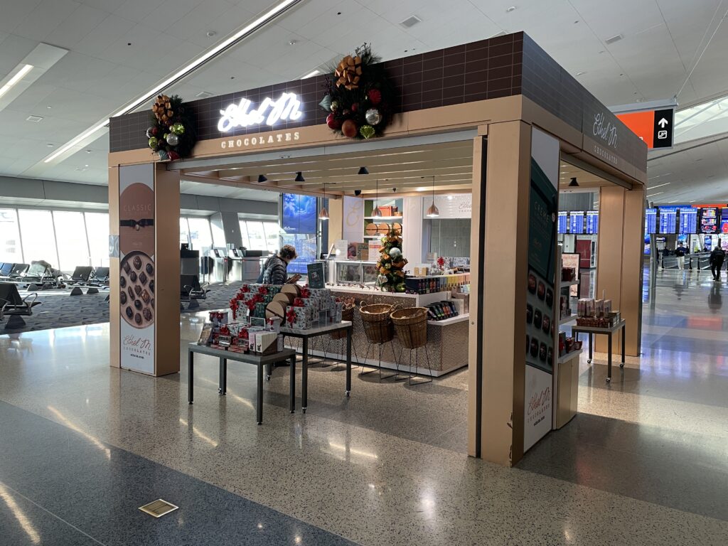 Ethel M Chocolate store in the middle of a main isle at the airport. 