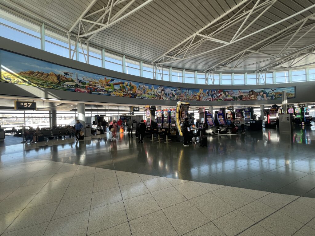 A large mural on the wall in D gates that depicts numerous historic Las Vegas casinos that no longer exist. 