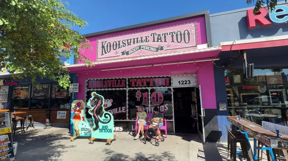 Exterior of Koolsville Tattoo, which is bright pink. 