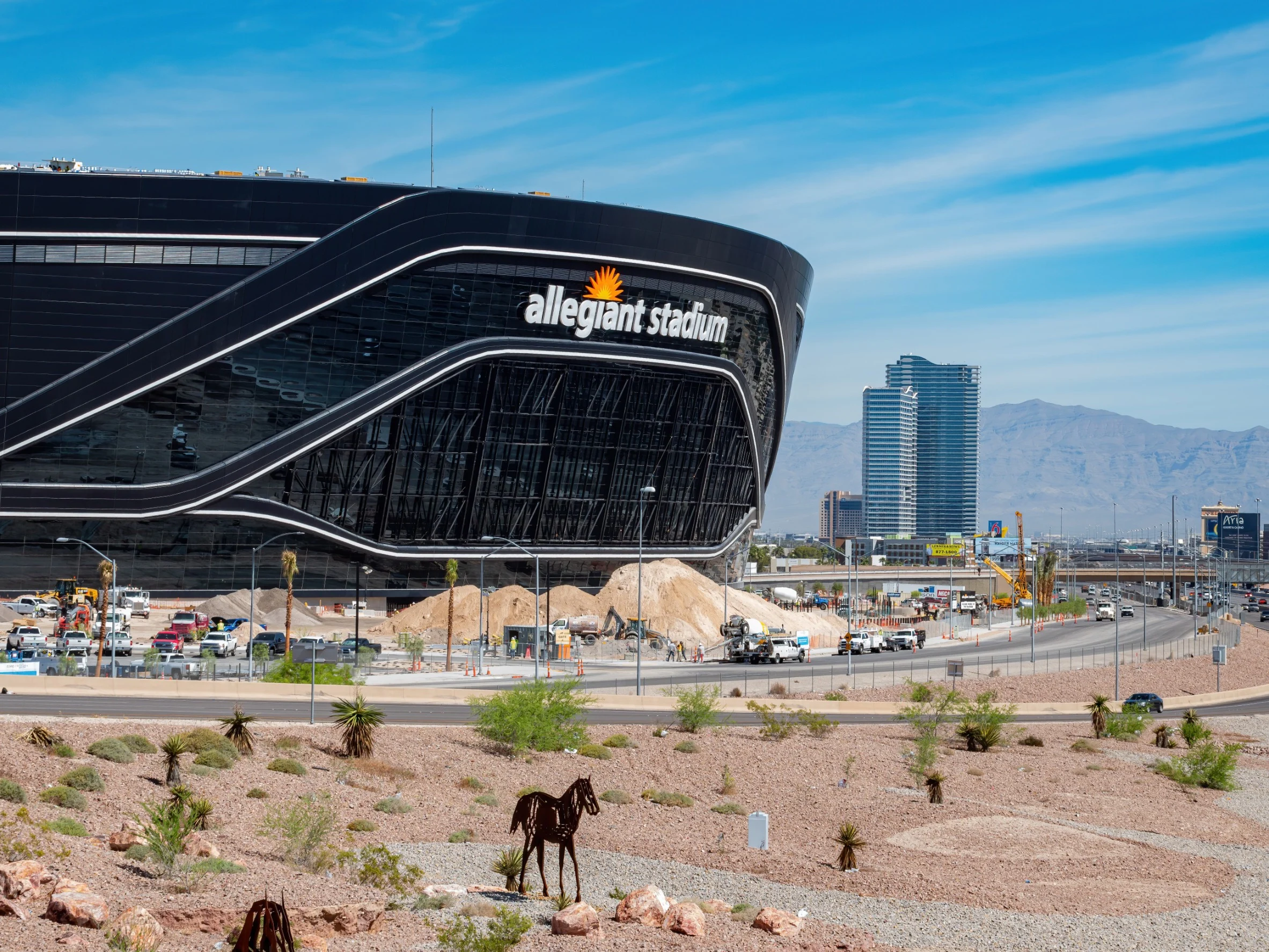 Exterior of Allegiant Stadium with desert landscape in the foreground.