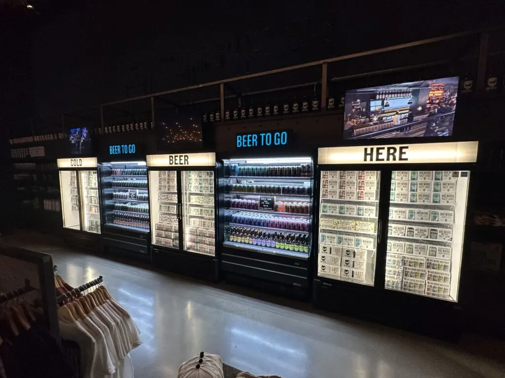 5 coolers stocked with individual and cases of beer at brewdog. 