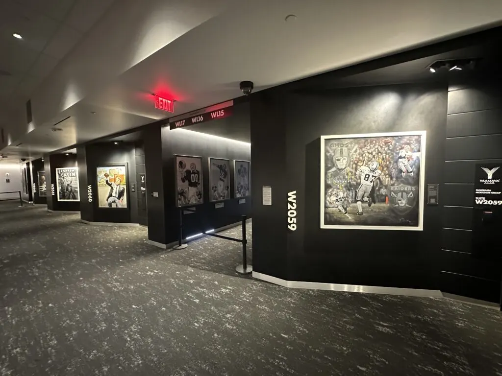 A concourse with large paintings depicting the Raiders' storied history. 