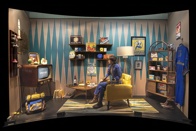 A set recreation of a character in Fallout sitting in their vault bedroom.