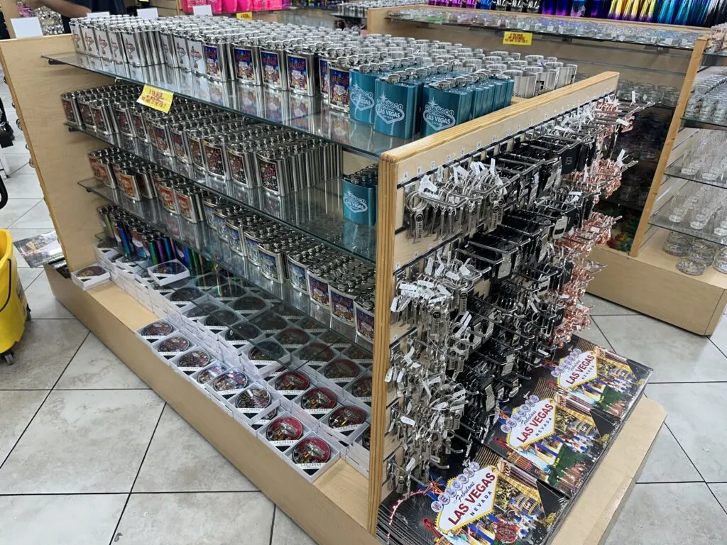 Various Flasks with the "Wecome to Las Vegas" Sign sit on a shelf.