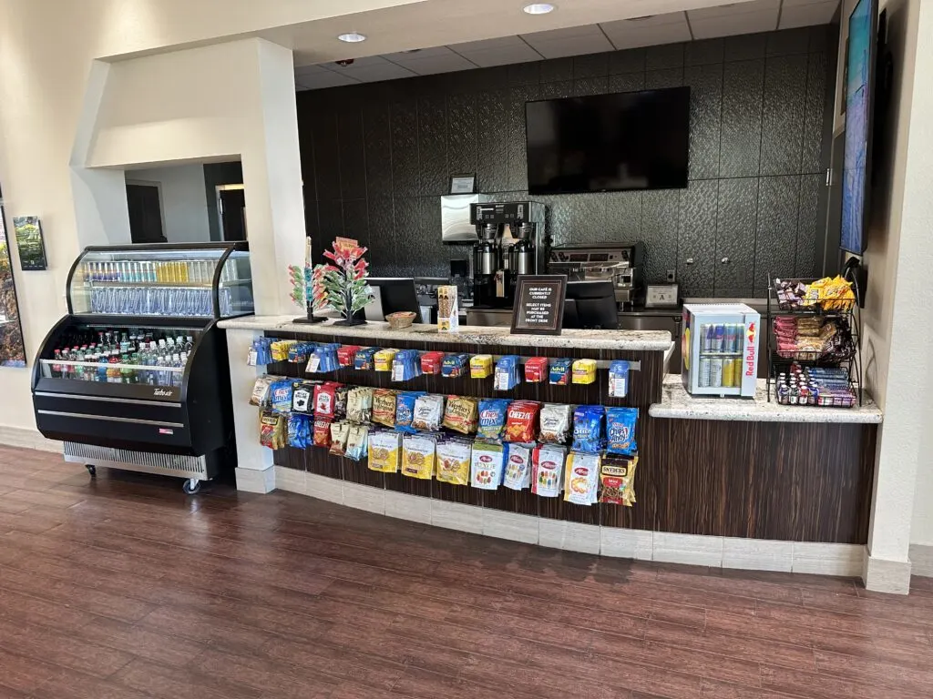 Snack bar inside maverick's lobby stocked with water, juices, sodas, and snacks. 