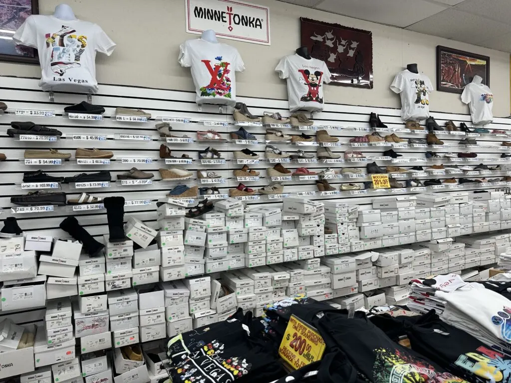 A wall full of Moccasin display models, and boxes down below. 