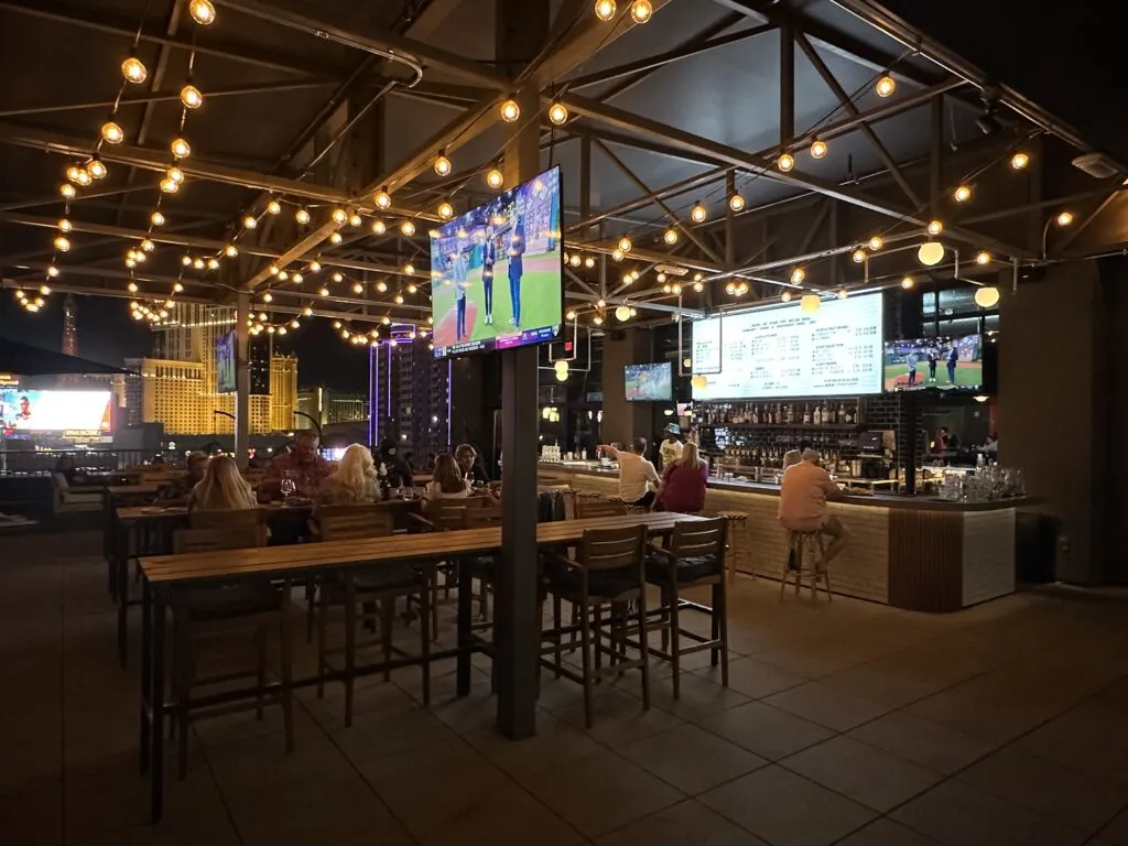 Outdoor bar on Brewdog's patio with decorative lighting hanging above it. 