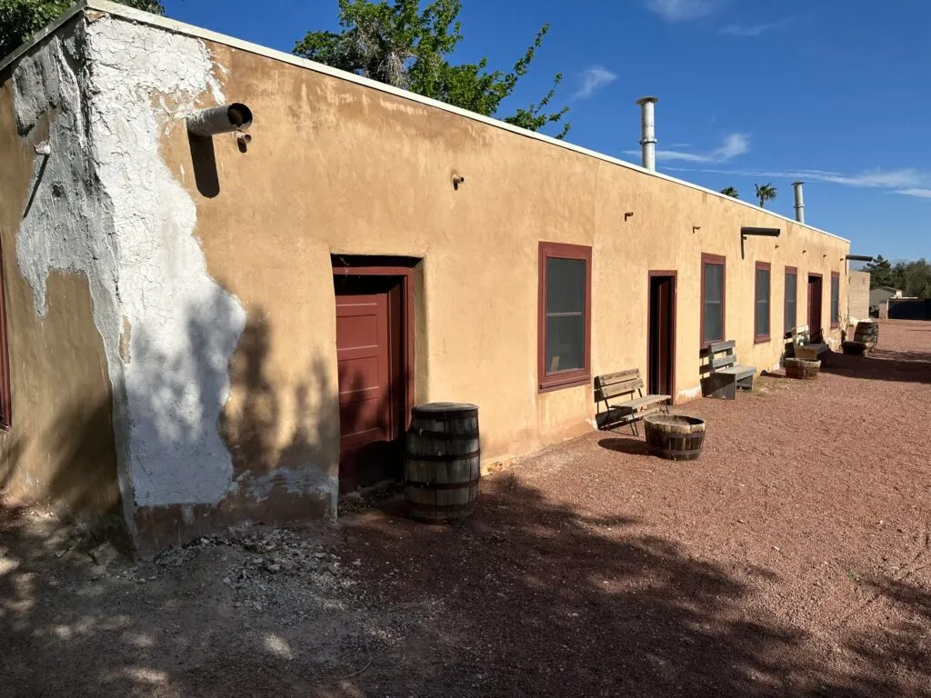 Another angle of the adobe building's exterior. The nearest corner is damaged and patched up with white plaster.