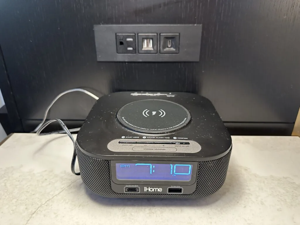 iHome alarm clock with charging pad on top. 