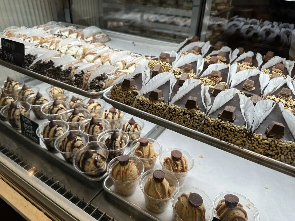 Assorted dessert options displayed under glass. 