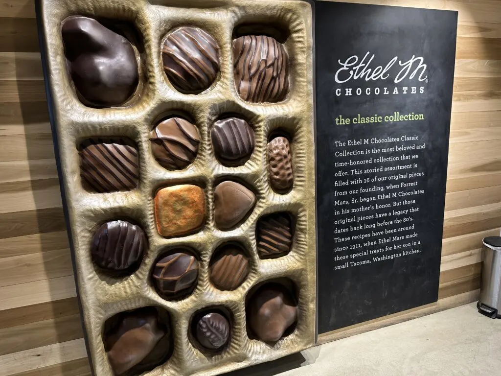 A selfie wall that imitates a large tray of assorted chocoltes. 