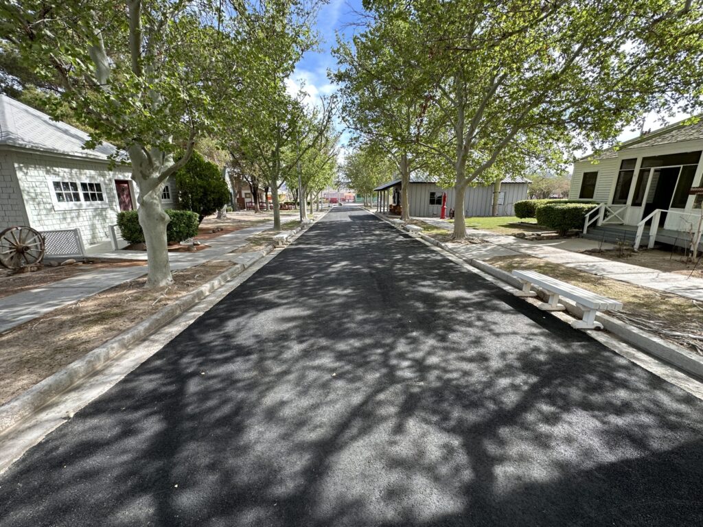 A look down Heritage Street. Trees and houses line either side of the road.