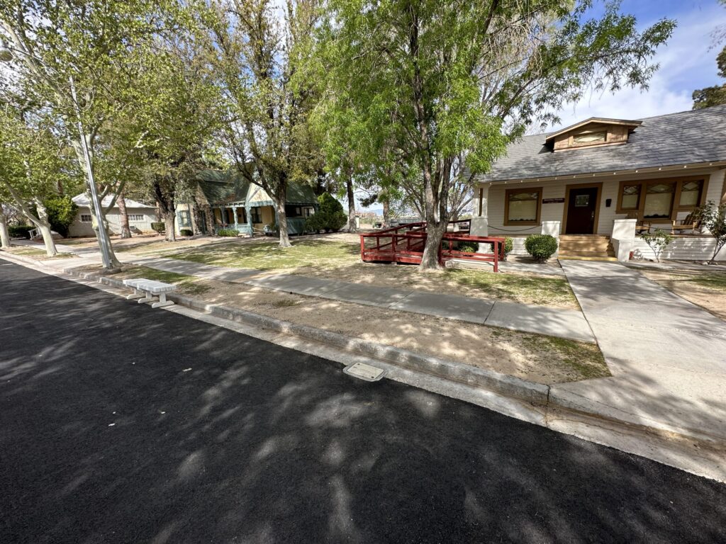 A few houses line the shaded Heritage Street.