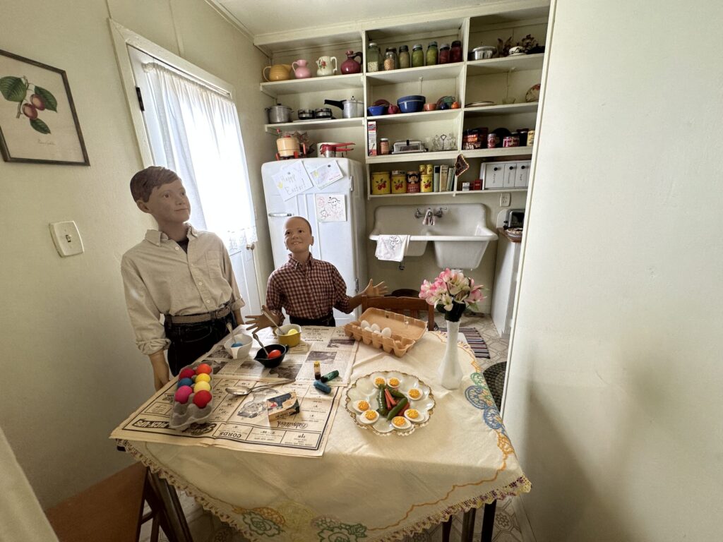 2 young boys decorating Easter Eggs at the kitchen table in a home along Heritage Street.