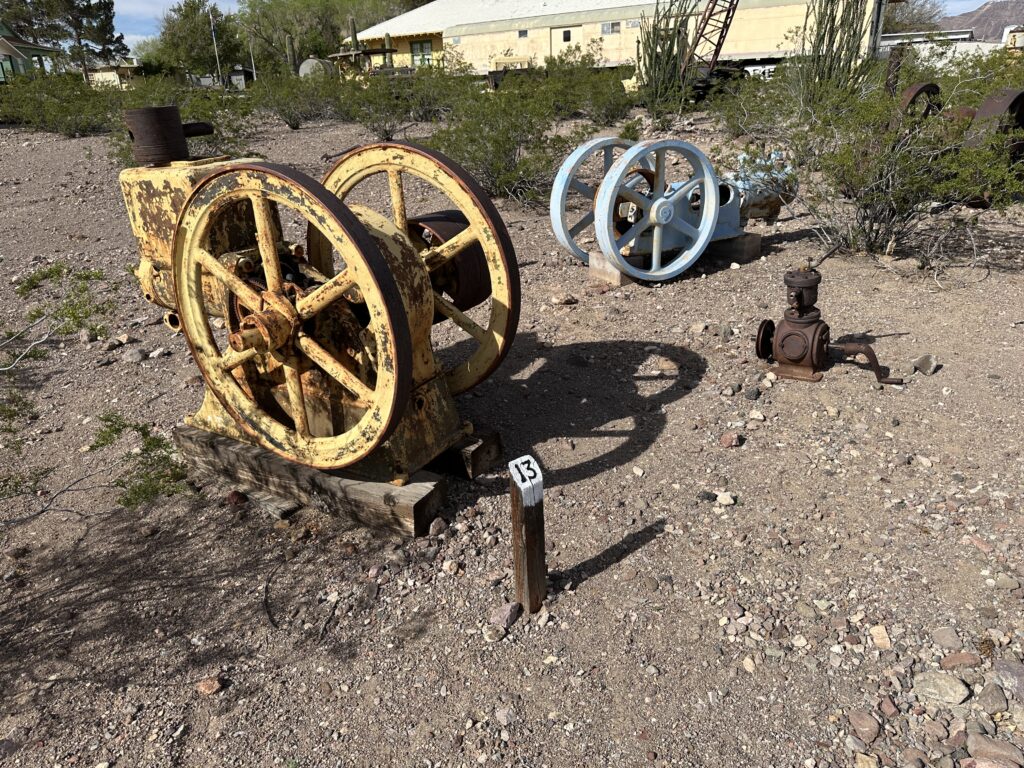 Miscalanious mining equipment that is rusting is scattered about the landscape. 