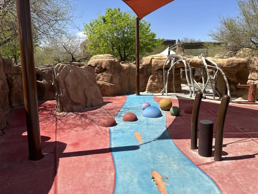 A rocky area with caves for kids to explore at the playground. 