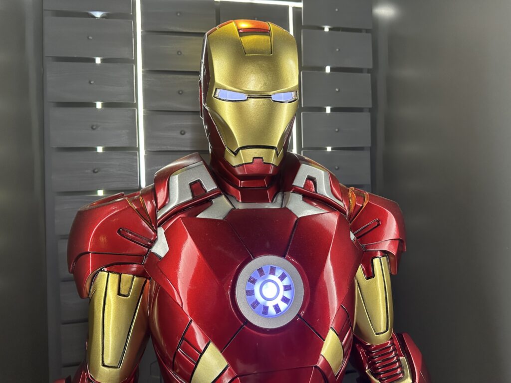 Iron Man's upper body, eyes peering into the camera. 