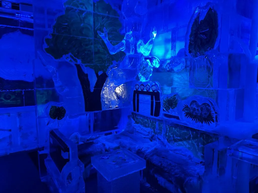 A corner booth with seating and a table in the Ice Bar.